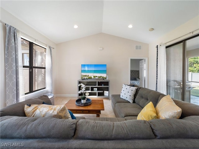 tiled living room featuring vaulted ceiling