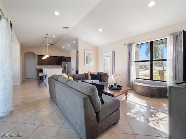 living room featuring lofted ceiling and light tile patterned floors