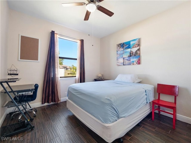 bedroom with dark hardwood / wood-style floors and ceiling fan