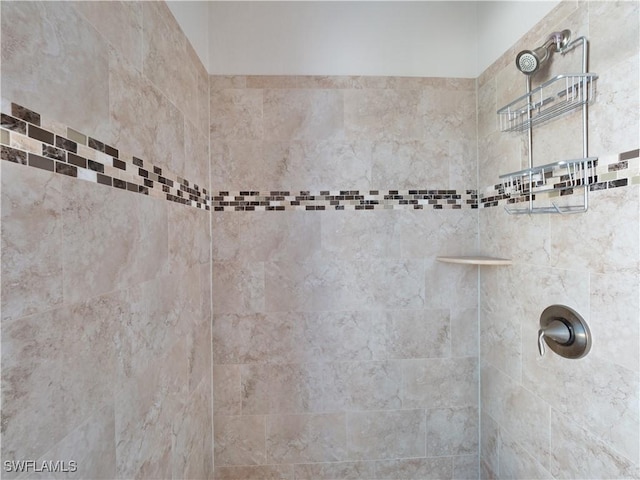 bathroom with tiled shower