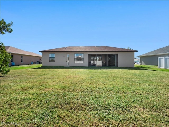 back of house featuring a yard