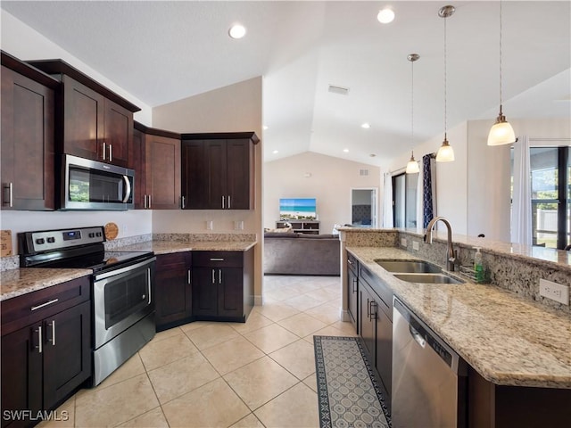 kitchen featuring dark brown cabinets, stainless steel appliances, vaulted ceiling, sink, and decorative light fixtures