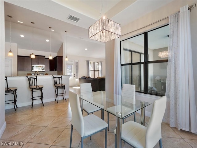 dining room featuring a chandelier and light tile patterned floors