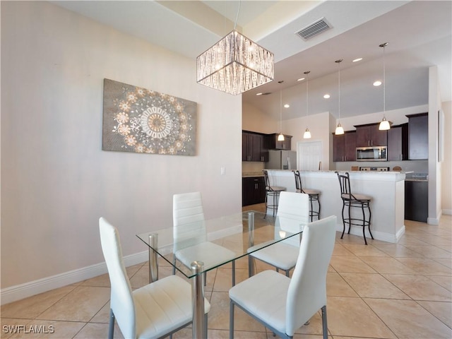 tiled dining area with a chandelier