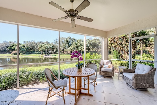 sunroom / solarium with a water view, a wealth of natural light, and ceiling fan