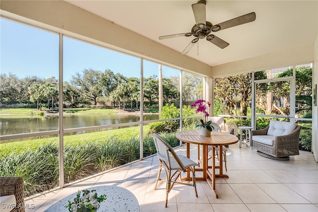 sunroom with a water view and ceiling fan