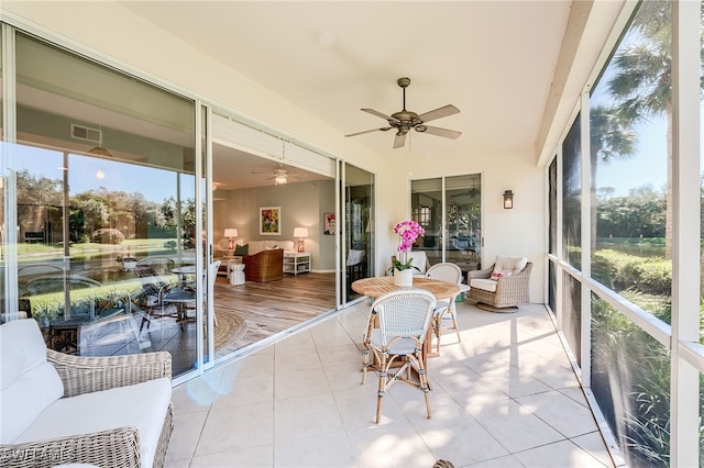 sunroom featuring ceiling fan