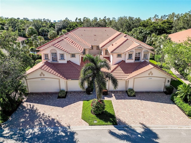 mediterranean / spanish-style house with a garage