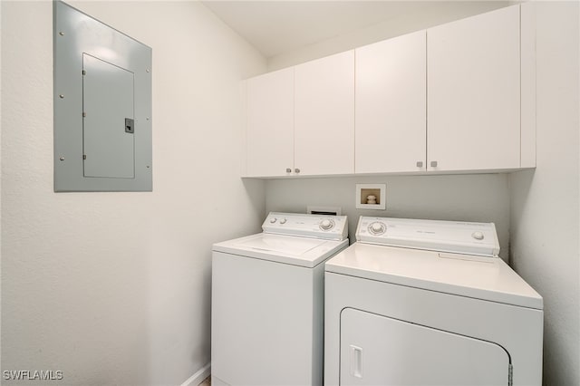 laundry area featuring cabinets, electric panel, and washer and dryer