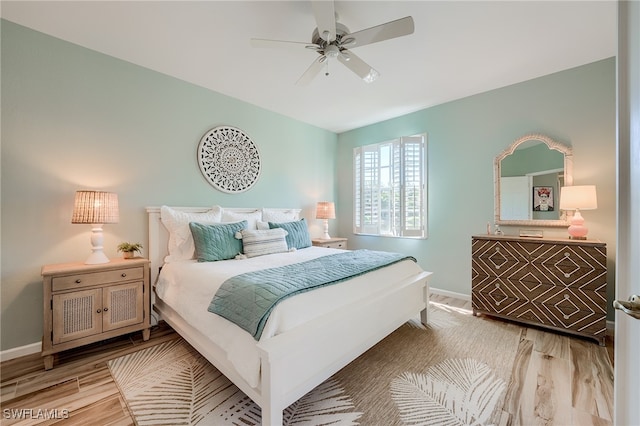 bedroom with ceiling fan and light hardwood / wood-style flooring