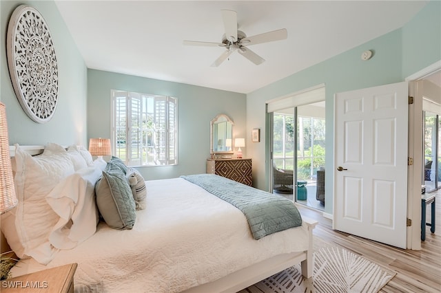 bedroom featuring multiple windows, light wood-type flooring, and access to exterior