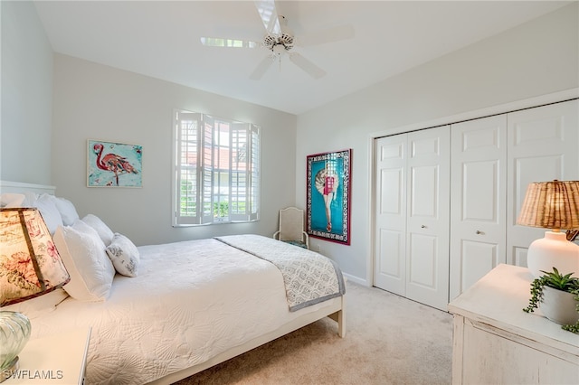 bedroom featuring light carpet, a closet, and ceiling fan