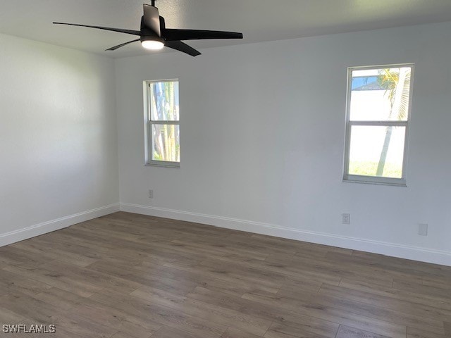 empty room with ceiling fan and wood-type flooring