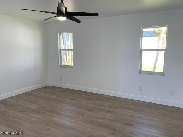 3026 SW 24th Ave, Cape Coral, FL 33914 - unfurnished room with healthy amount of natural light, wood finished floors, and baseboards