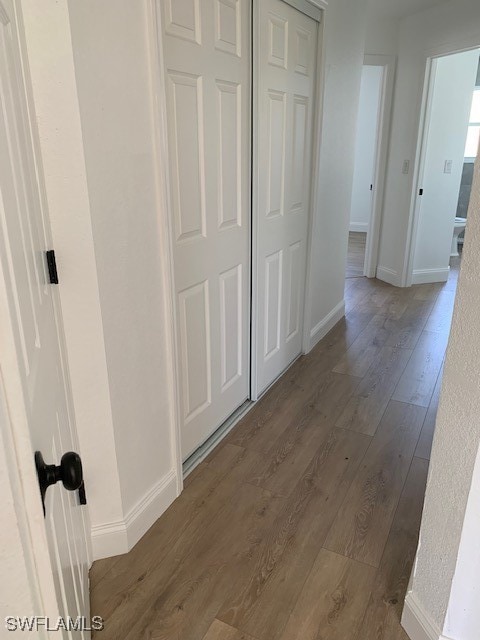 hall with dark hardwood / wood-style flooring