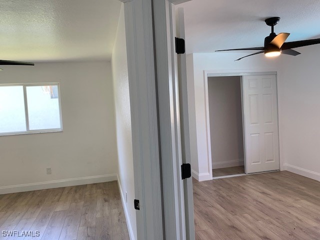 spare room featuring light hardwood / wood-style flooring and ceiling fan