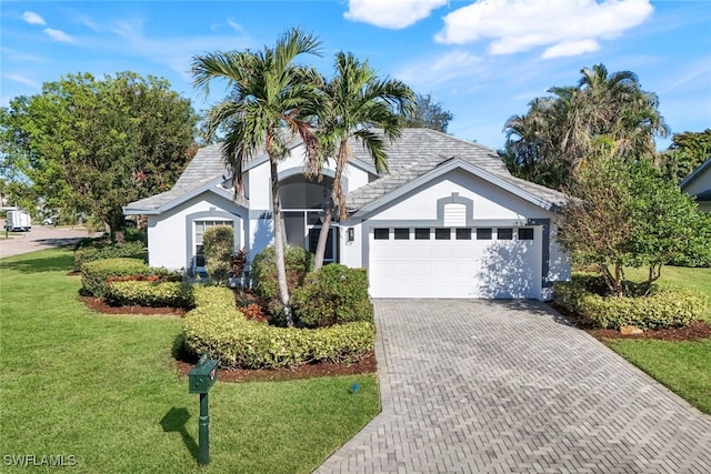 ranch-style home with a front yard and a garage