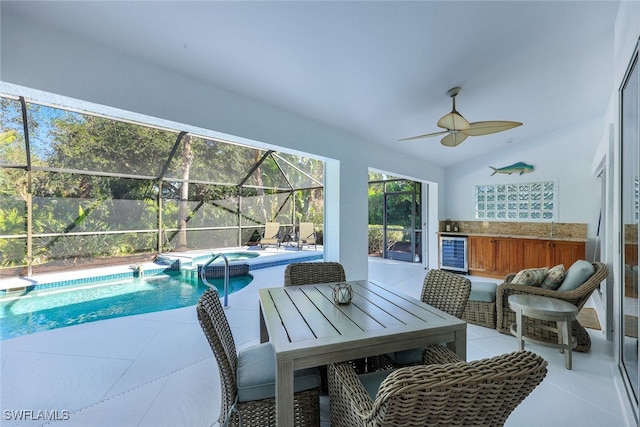 view of pool featuring an in ground hot tub, a patio, and ceiling fan