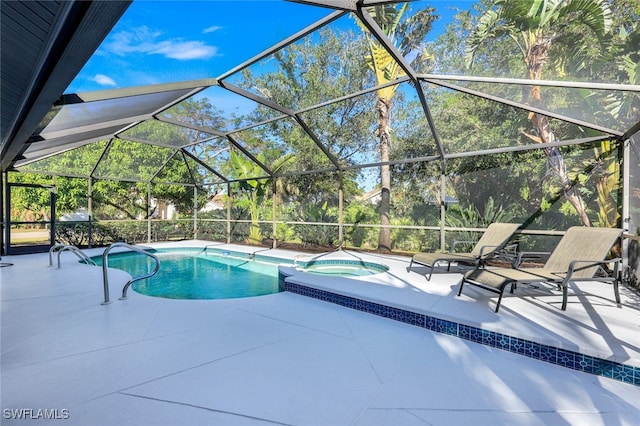 view of pool featuring an in ground hot tub, a patio, and a lanai