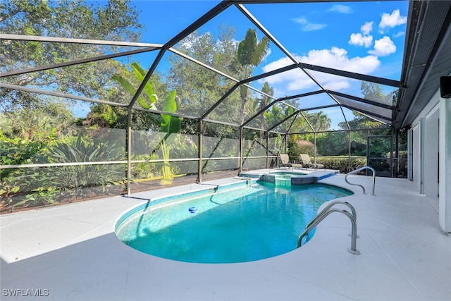 view of swimming pool featuring a patio area, a lanai, and an in ground hot tub