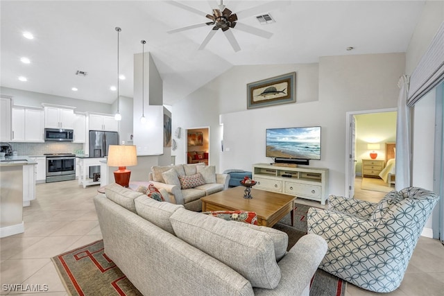 tiled living room with ceiling fan and high vaulted ceiling