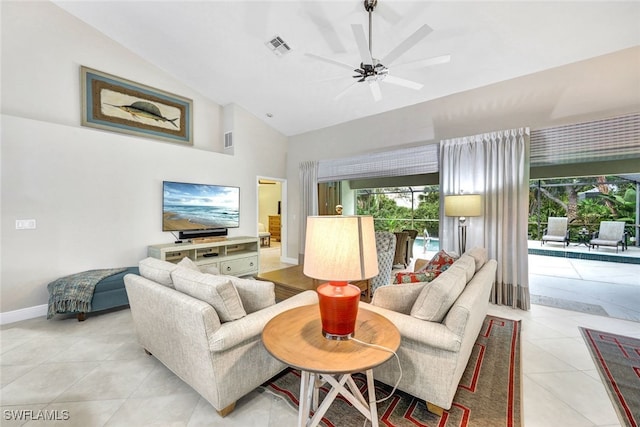 living room featuring ceiling fan, light tile patterned floors, and vaulted ceiling