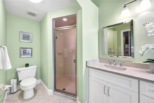 bathroom with toilet, vanity, tile patterned floors, and walk in shower