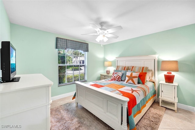 tiled bedroom featuring ceiling fan