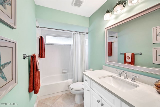 full bathroom featuring tile patterned flooring, vanity, toilet, and shower / bath combo with shower curtain