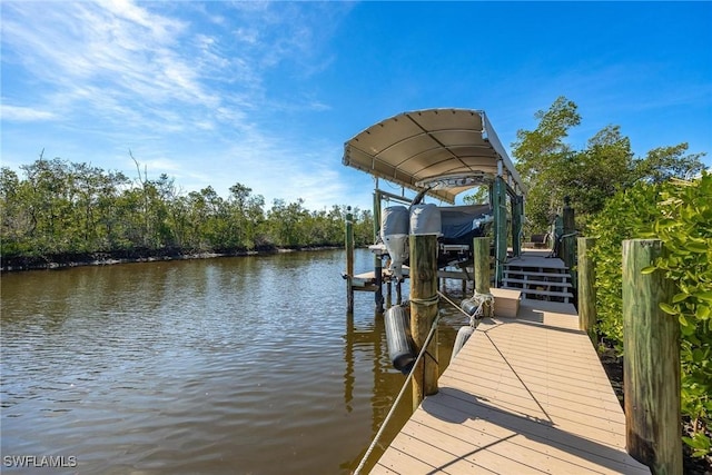 dock area with a water view and boat lift