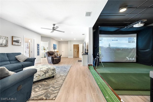 rec room featuring baseboards, visible vents, ceiling fan, wood finished floors, and golf simulator