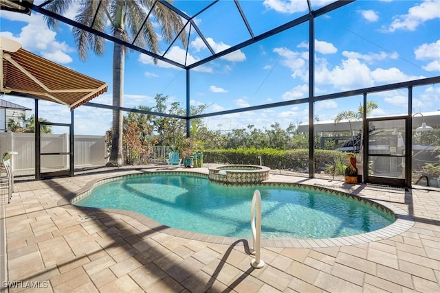 view of pool featuring a patio area, glass enclosure, and an in ground hot tub