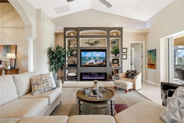 living room featuring high vaulted ceiling, tile patterned flooring, arched walkways, and a glass covered fireplace