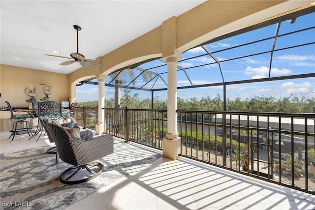 view of patio / terrace featuring a lanai and a ceiling fan