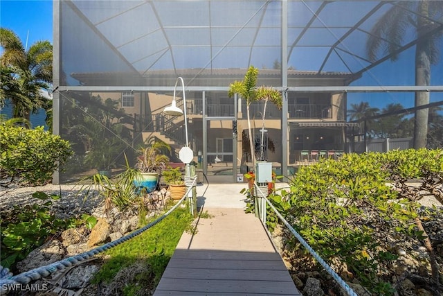 rear view of property featuring a lanai