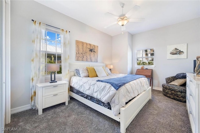 bedroom featuring dark colored carpet, a ceiling fan, and baseboards