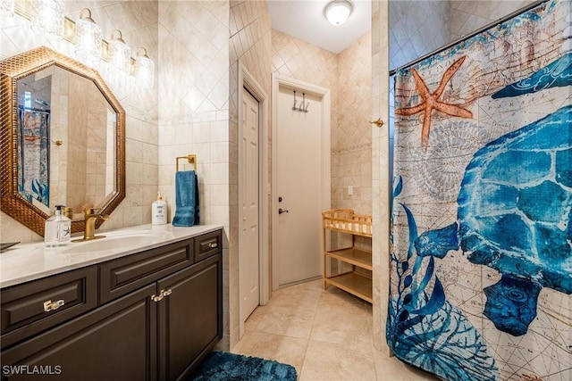 full bathroom with vanity, tile walls, and tile patterned floors