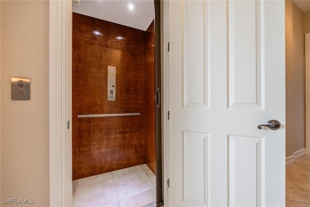 bathroom with tile patterned flooring and elevator