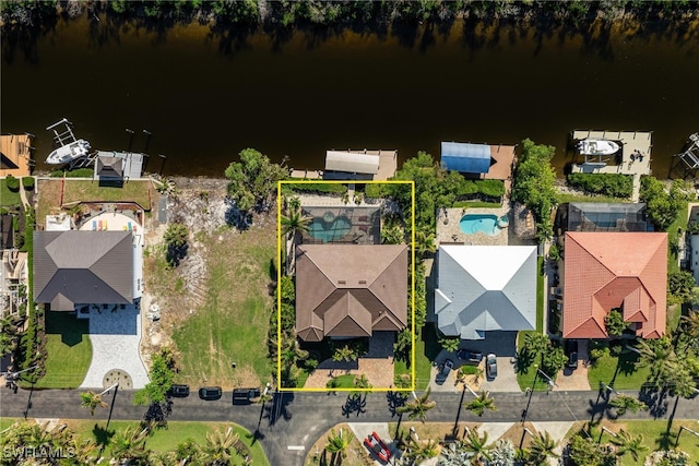 drone / aerial view with a water view and a residential view