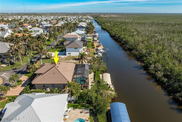 drone / aerial view with a water view and a residential view