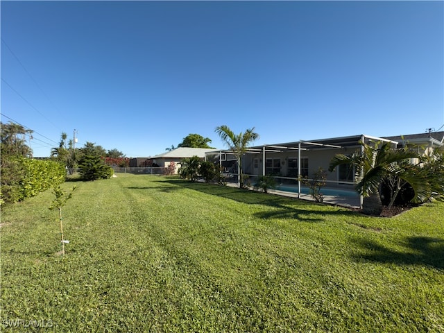 view of yard featuring glass enclosure