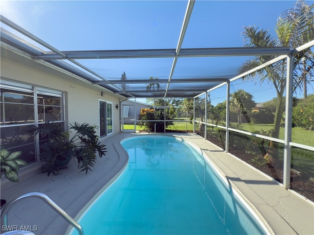 view of pool featuring glass enclosure