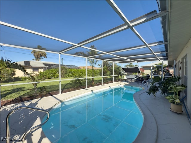 view of swimming pool with a lanai and a patio area