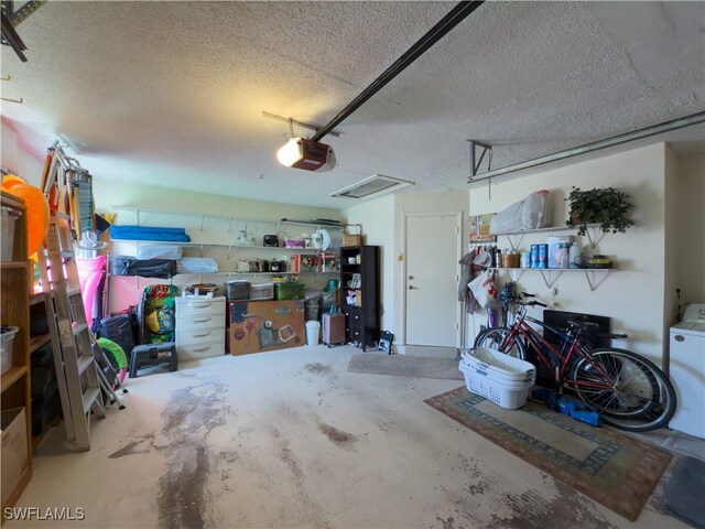 garage featuring washer / dryer and a garage door opener