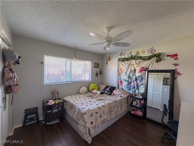 bedroom featuring a textured ceiling, dark hardwood / wood-style flooring, and ceiling fan