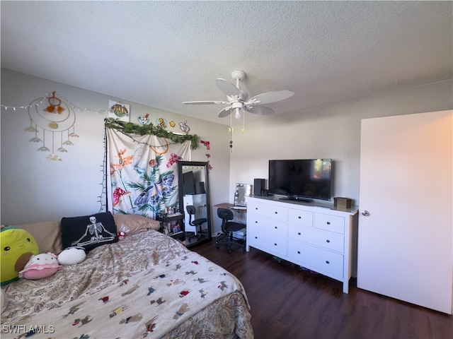 bedroom with a textured ceiling, ceiling fan, and dark wood-type flooring