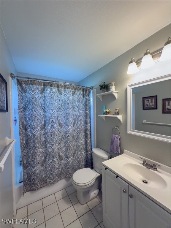 full bathroom featuring tile patterned flooring, vanity, toilet, and shower / bathtub combination with curtain