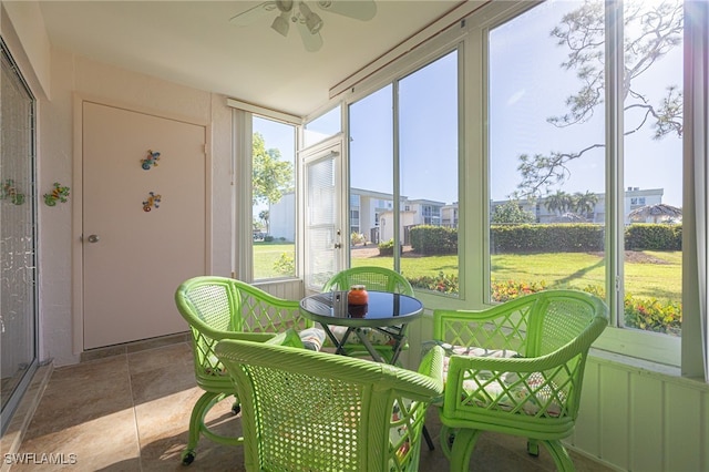 sunroom featuring ceiling fan