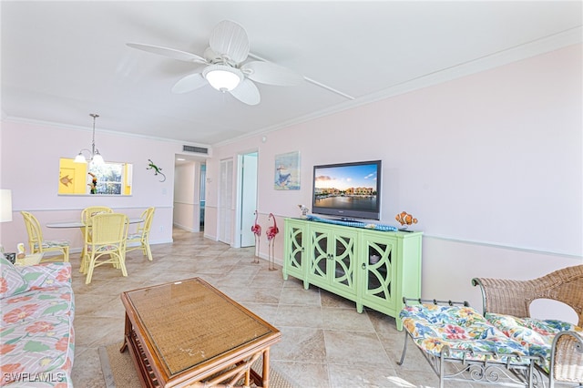 living room with ceiling fan and ornamental molding