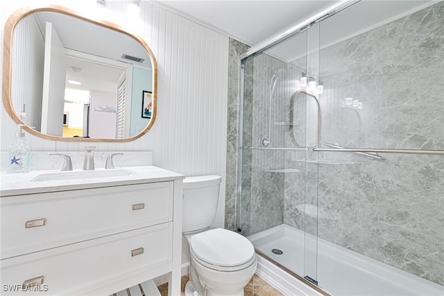 bathroom with vanity, a shower with shower door, and toilet